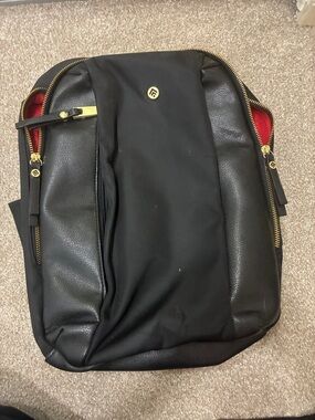 Women's Black Backpack with Gold Accents and Red Interior